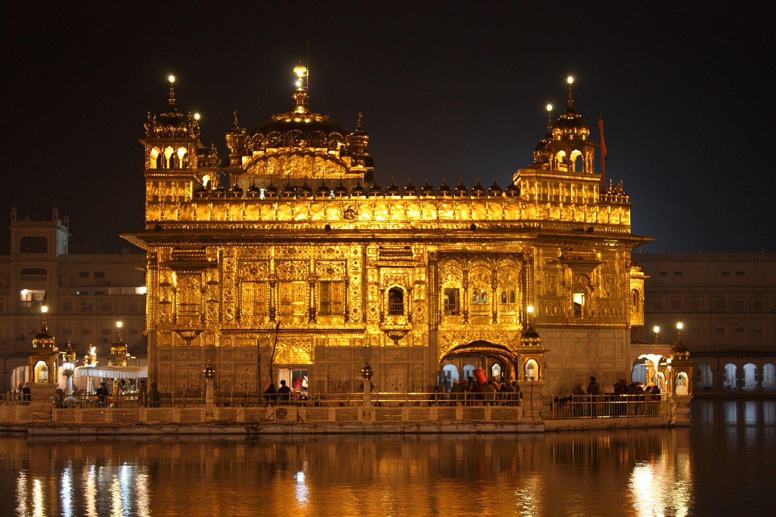 Golden Temple | Sikh Saints The Golden Temple in Amritsar glows at night, beautifully reflected in the water around it.