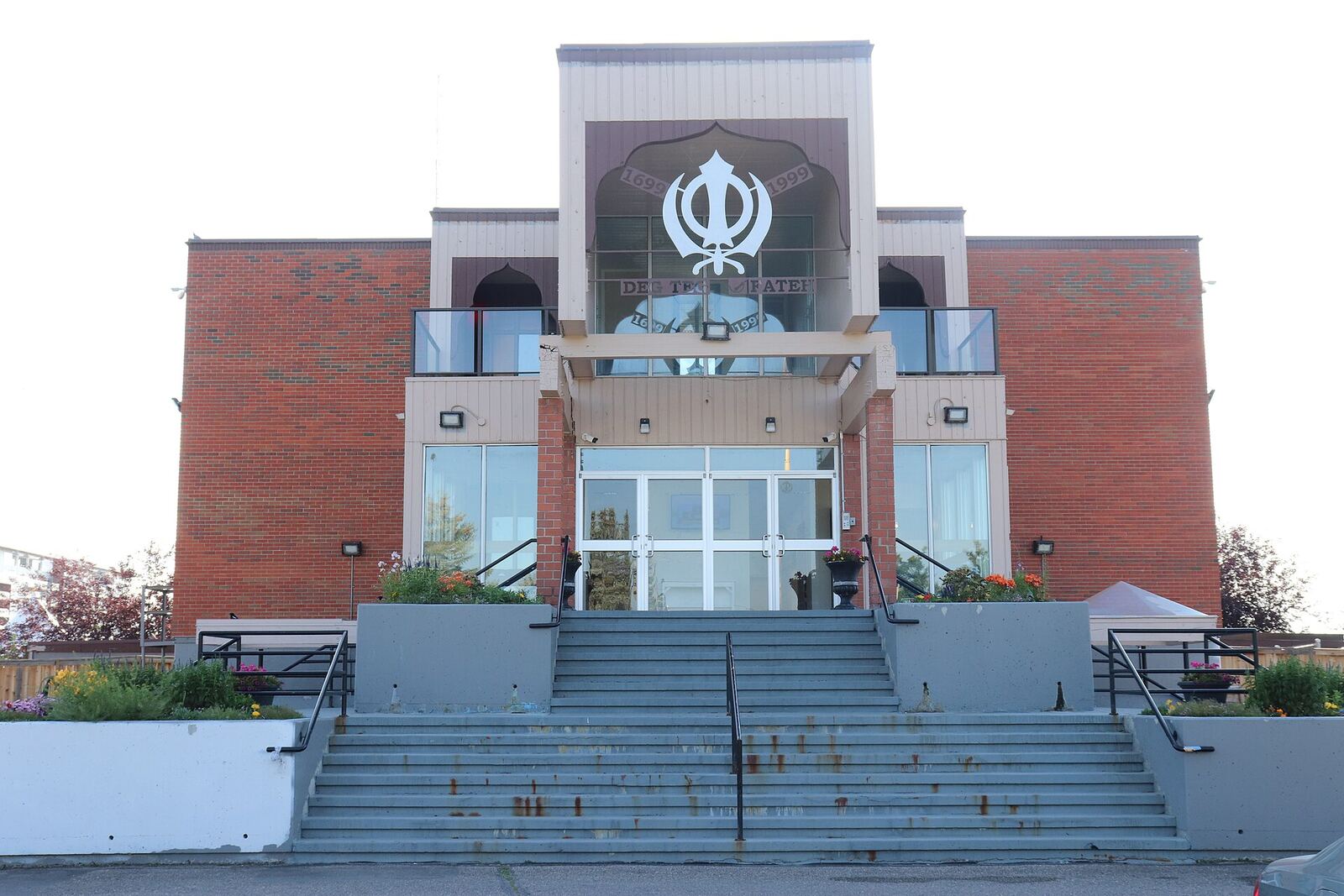 Gurdwara | Sikh Saints A Gurdwara building with a central staircase and Sikh symbol, representing the heart of Sikh community practice.