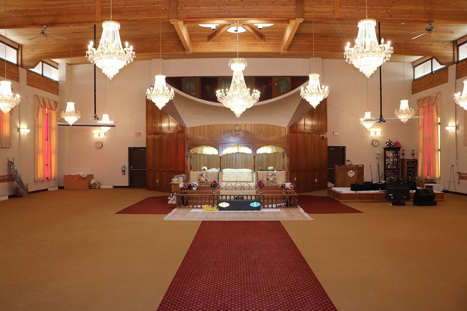 Gurdwara Calgary | Sikh Saints The main hall of Gurdwara Sikh Society Calgary shows ornate chandeliers and a red carpet, reflecting Sikh community practice.