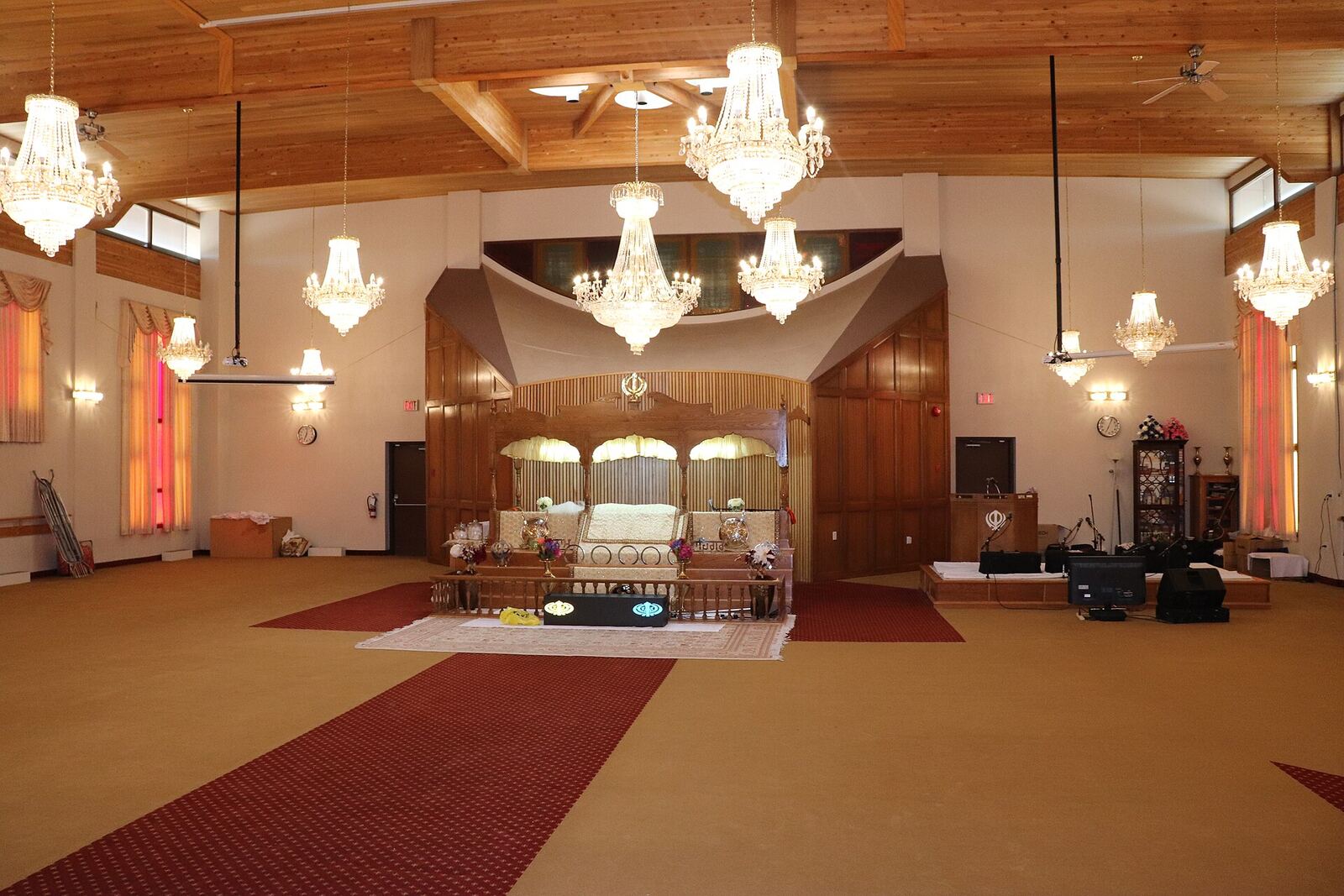 Gurdwara Main Hall | Sikh Saints A Gurdwara's main hall showcases ornate chandeliers and a central platform, representing Sikh faith.