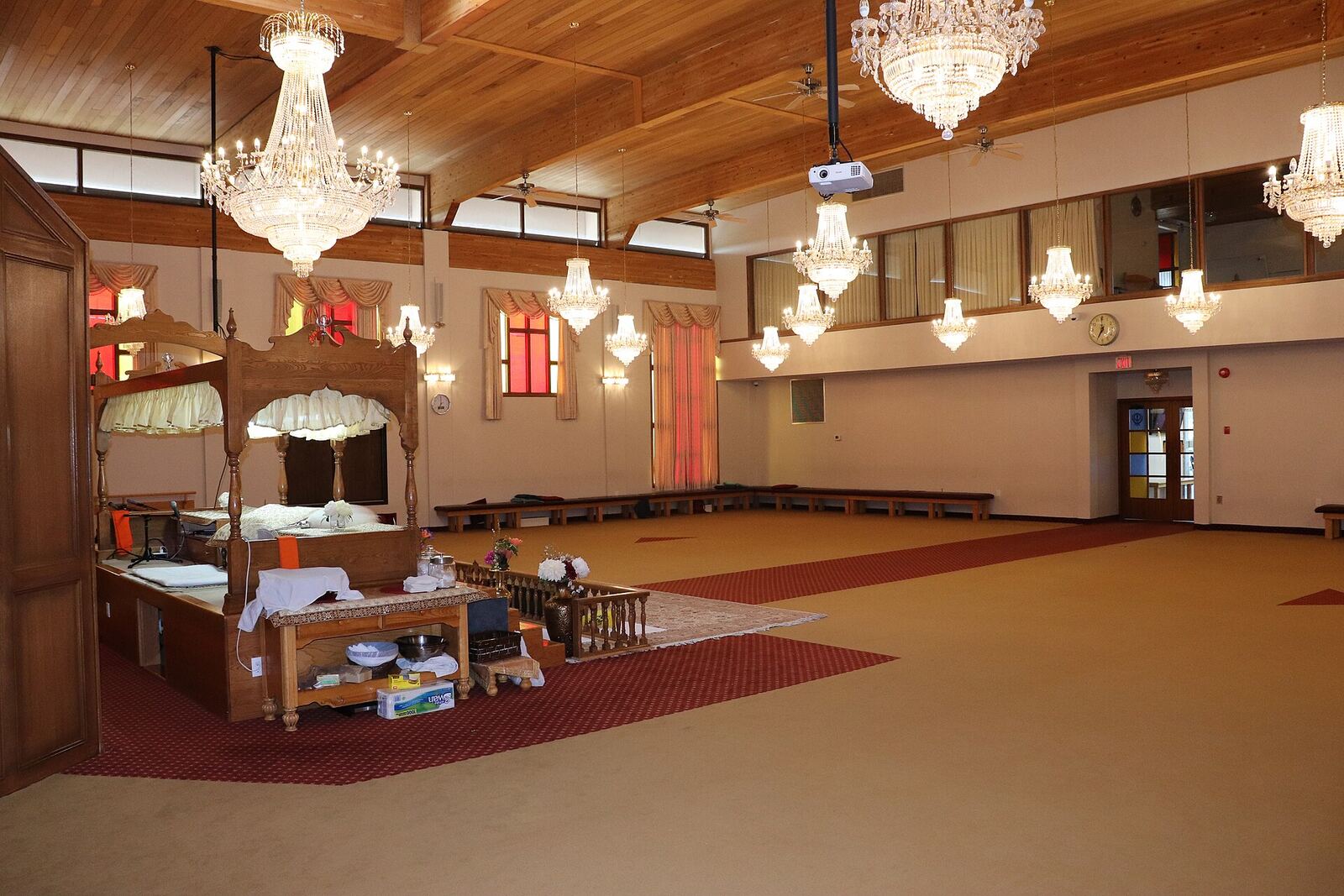 Gurdwara Main Hall | Sikh Saints A Gurdwara's main hall shows ornate chandeliers and a raised platform, reflecting Sikh faith traditions.